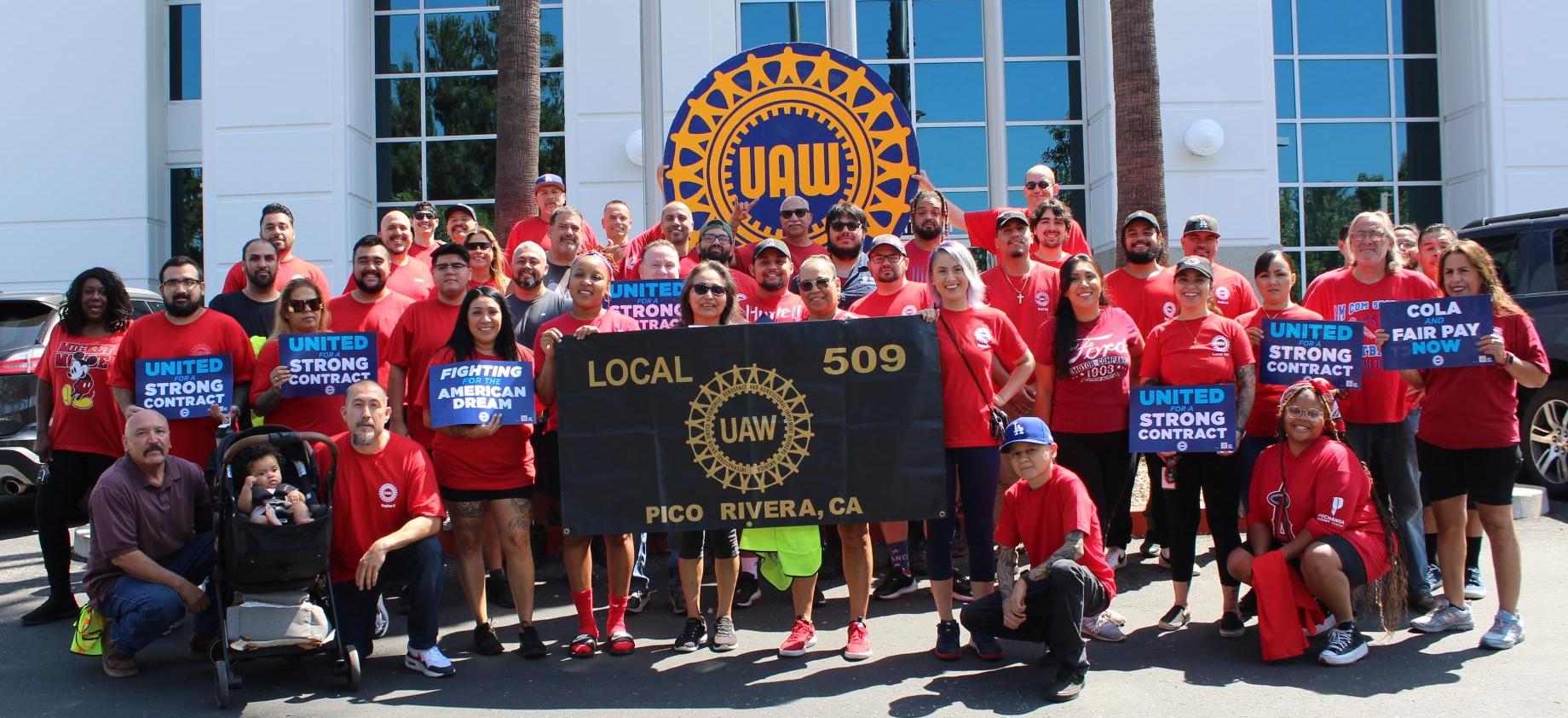 Large group of UAW 509 members in red shirts posed for a photo 